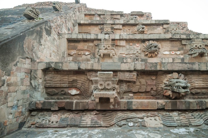 View of the facade of the Feathered Serpent Pyramid, assembled as a mosaic of large and small sculptures.